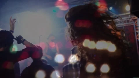 Beat dropping dancers pointing and headbanging DJ mixing for music energy in Stock Footage 328007369