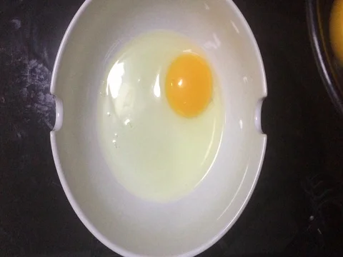 Beat the egg in a white bowl. 스톡 동영상 76859397
