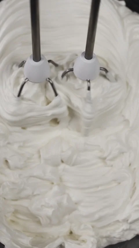 Beat the hen's eggs with a mixer into a white creamy mass. 動画素材 281668405