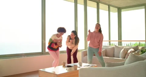 Beat picking up, three women singing into mics, dancing steps around coffee Stock Footage 340069182