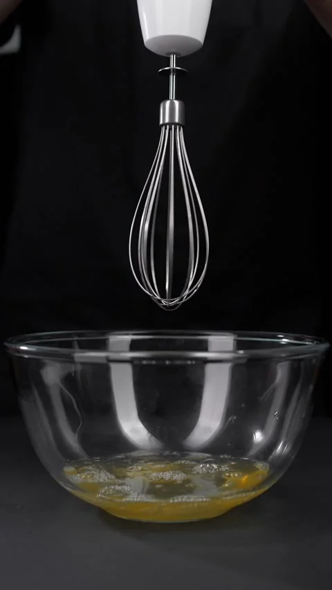 Beat raw chicken eggs using an electric mixer. Stock Footage 281666504