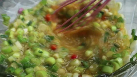 Beaten chicken egg mixed with spring onions Video stock 269268070