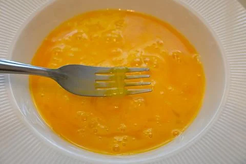 Beaten egg in a bowl 库存照片