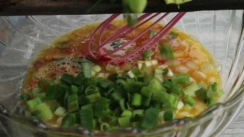 Beaten egg mixed with spring onions Video stock 269268116