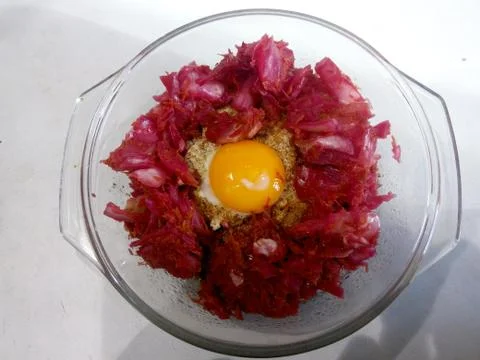 Beaten egg with salad and cheese in a transparent plate Stock Photos