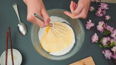 Beaten egg whites mixed with raw yolks Stock Footage 252383744
