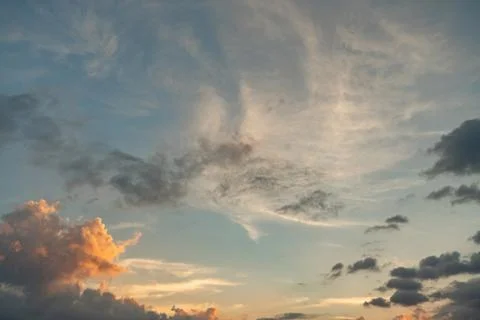 Beatiful blue cloudy sky in sunset colors Stock Photos