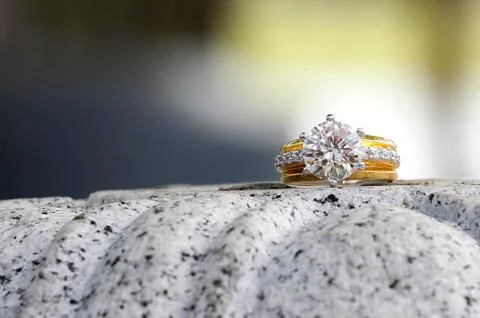 Beatiful diamond ring sitting on granite stone 스톡 사진