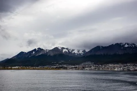 Beatiful dramatic view of the beagle channel, with snow capped mountain and t Stock Photos