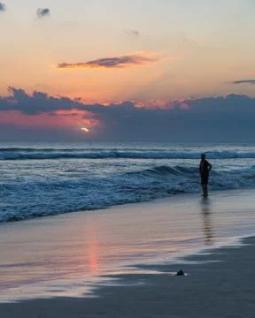 Beatiful sunset and silhouette of a man on Seminyak beach, Bali Stock Photos