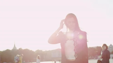 Beatiful young woman posing, touching her hair and smiling Stock Footage 69002255