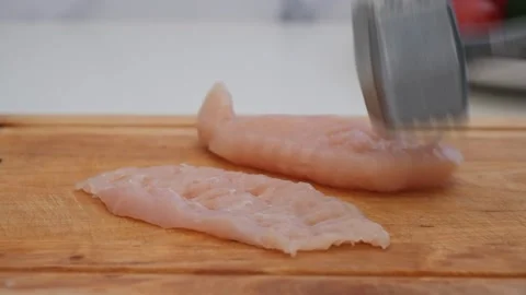 Beating chicken chops. Home cooking Stock Footage 285423577