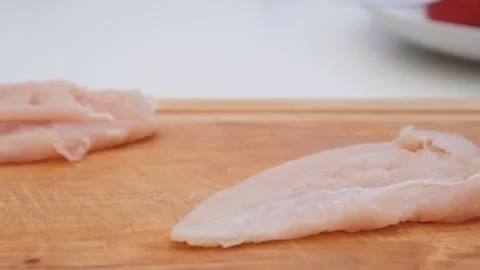 Beating chicken chops. Home cooking Stock Footage 285423583
