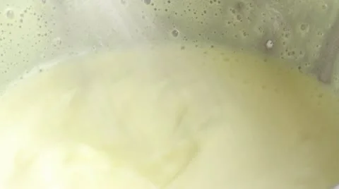 Beating creme in bowl over pan of simmering water Stock Footage 24665568