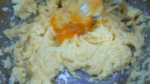 Beating dough with egg of a food processor in slow motion Stock Footage 150728474
