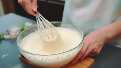 Beating the dough with a hand whisk. Preparing batter for cake Stock-Footage 252336335