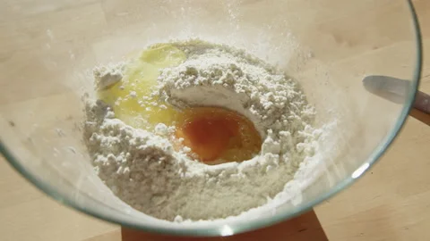 Beating the Egg Into a Flour Stock Footage 217405838