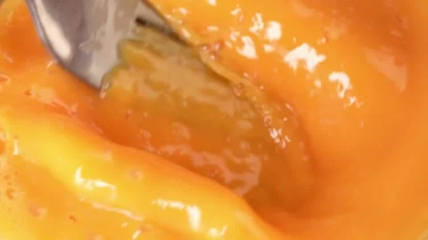 Beating an egg with a fork. close-up. Stock Footage 245355300