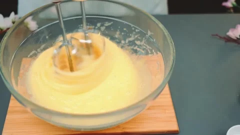 Beating the egg mass with a kitchen blender Stock Footage 252497335