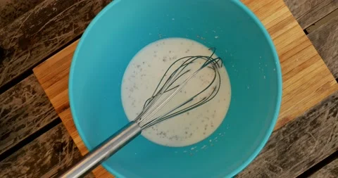 Beating egg in milk and yeast mix Video stock 130791241