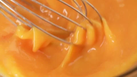 Beating an egg with a whisk. close-up. Stock Footage 245343620