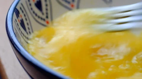 Beating egg yolk with fork Stock Footage 39564179