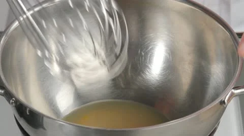 Beating egg yolk until pale and creamy Stock Footage 24667814