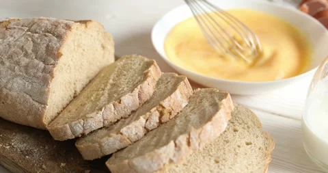Beating eggs and milk with a whisk in a plate. Dolly shot. Stock Footage 250105353