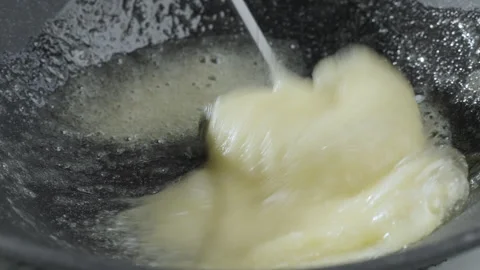 Beating eggs and sugar to make a sweet dish. Preparation of pancake batter. Stock Footage 263068570