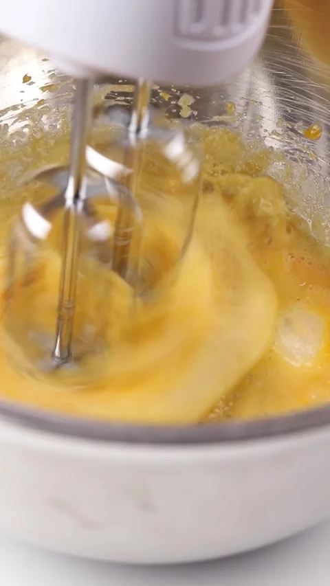 Beating eggs in bowl with electric mixer Stock Footage 290804941