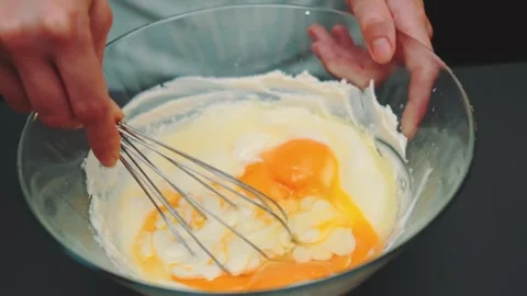 Beating eggs in a deep bowl with a whisk Stock Footage 250266560
