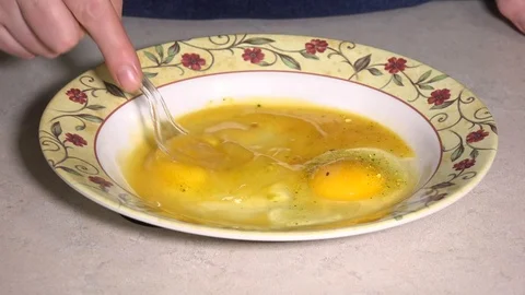 Beating eggs in dish Stock Footage 106648189
