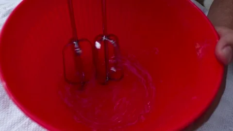 Beating eggs in a red bowl. Stock Footage 162164198