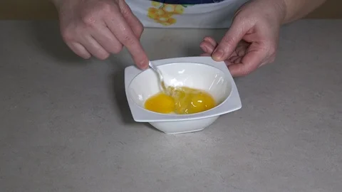 Beating eggs in small bowl Stock Footage 106648050