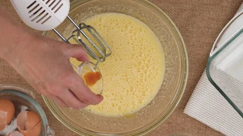 Beating eggs with sugar plus vanilla extract. Apple cake recipe Stock Footage 169419866