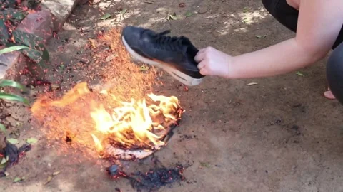 Beating fire with a shoe Video stock 153657251