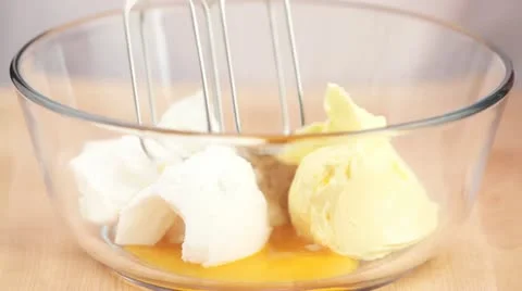 Beating ingredients for biscuit dough together with an electric whisk Video stock 24663288