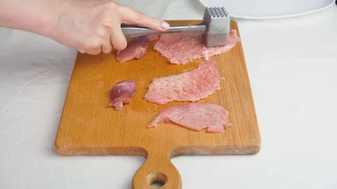 Beating meat with a hammer. 4K. Stock-Footage 129148357