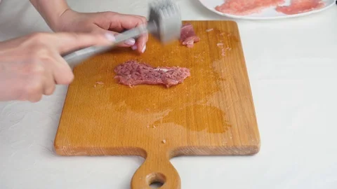 Beating meat with a hammer. Stock-Footage 129761380
