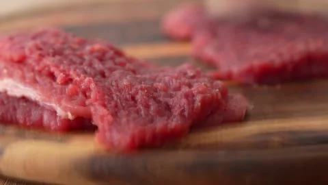 Beating raw meat on a wooden board. Stock Footage 256224366