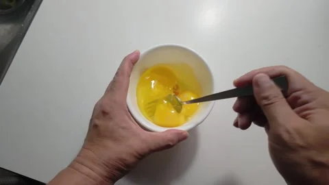 Beating Three Eggs with a Stainless Steel Fork Stock Footage 346303492