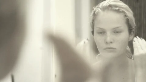 Beauiful Young Female Adding Face Cream In Front Of The Mirror Stock Footage 99066083