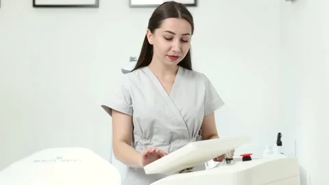 Beautician adjusts the parameters on the display before laser hair removal Stock Footage 229174035