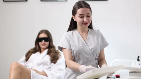 Beautician adjusts the parameters on the display before laser hair removal Stock Footage 229174108