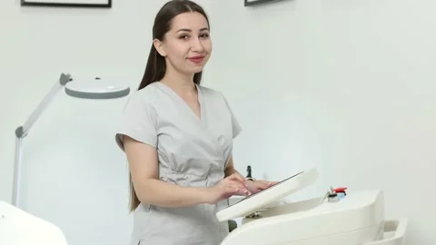 Beautician adjusts the parameters on the display before laser hair removal Stock Footage 229333866