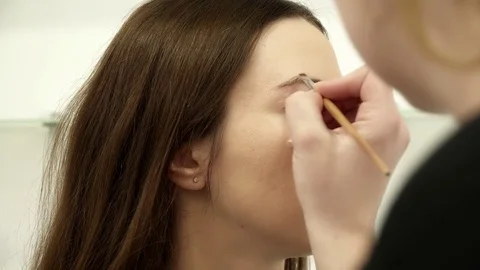 Beautician is coloring the eyebrows Stock Footage 73823645