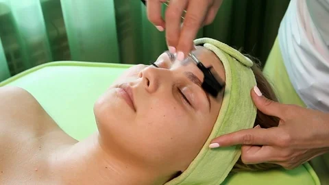 Beautician hand combing eyebrows to client Stock Footage 125145454