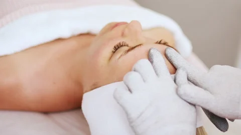 Beautician makes microcurrent procedure on face Stock Footage 214040450