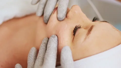 Beautician makes a procedure on cheekbones  with microcurrent Stock Footage 221261374