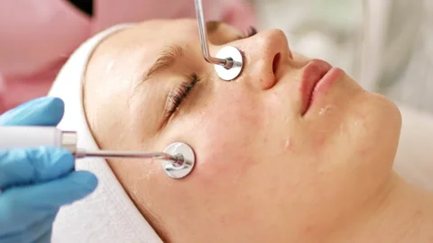 Beautician makes a procedure on cheekbones with microcurrent Stock Footage 221261843